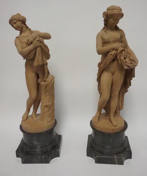 PAIR OF TERRA COTTA STATUES OF WOMEN: PAIR OF TERRA COTTA STATUES OF WOMEN W/ FAUX MARBLE BASES 22 IN H
