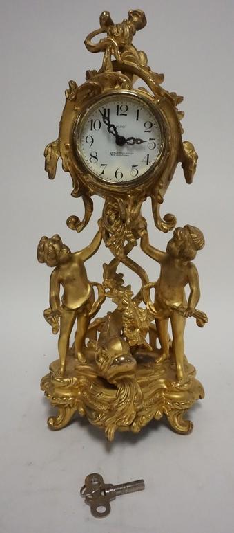 NEW HAVEN GILT FIGURAL CLOCK: NEW HAVEN GILT FIGURAL CLOCK W/ DOLPHIN AND PUTI 8 DAY 14 3/4 IN H