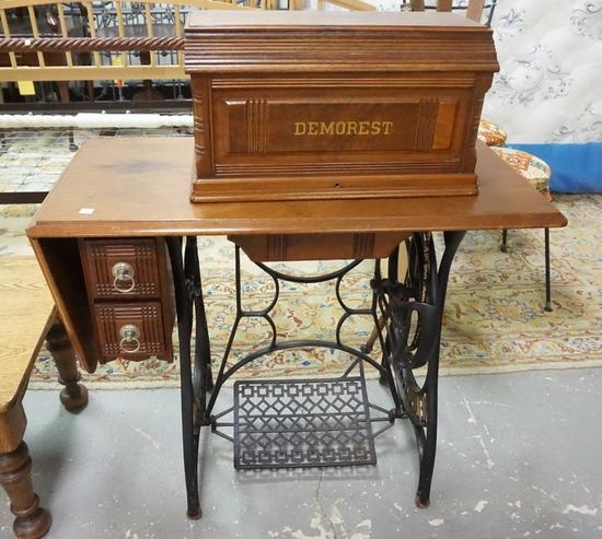 DEMORAST WALNUT TREADLE SEWING MACHINE: DEMORAST WALNUT TREADLE SEWING MACHINE WITH GOOD LITHO. NAME STAMPED IN GOLD ON THE WALNUT COVER. FROM A SEWING FACTORY IN COLUMBIA NJ