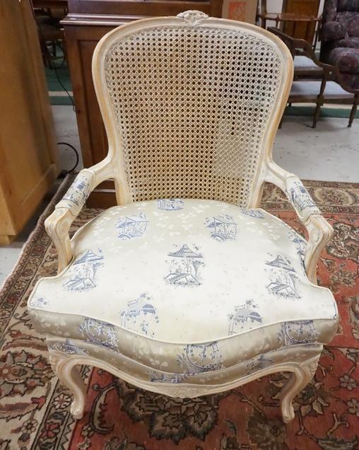 CARVED FRENCH STYLE CANE BACK ARM CHAIR: CARVED FRENCH STYLE CANE BACK ARM CHAIR W/ UPHOLSTERED SEATS AND ARM RESTS, PAINTED WHITE