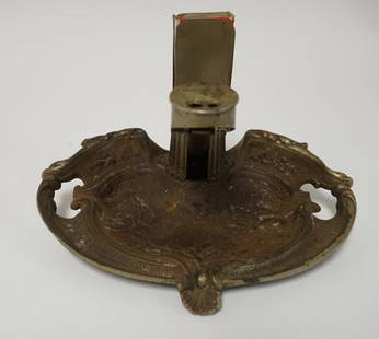 BRUNHOFF CAST IRON ASHTRAY W.CIGAR CUTTER: VICTORIAN CAST IRON ASH TRAY WITH SPRING LOADED CIGAR CUTTER. THE BRUNHOFF MFG CO, CINCINNATI OHIO. TOP OF CIGAR CUTTER MARKED PATENT PENDING. 9 IN WIDE. HAS A BRASS MATCHBOOK HOLDER ATTACHED.