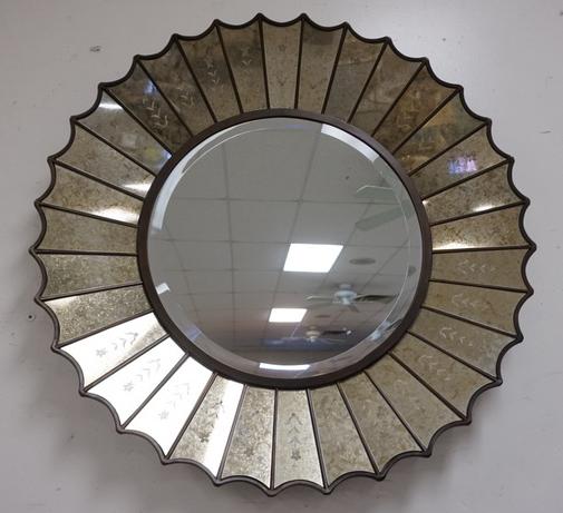 SUNBURST MIRROR. BEVELED AND DECORATED: SUNBURST BEVELED MIRROR WITH DECORATED MIRROR FRAME AND SCALLOPED RIM. 32 IN DIAMETER
