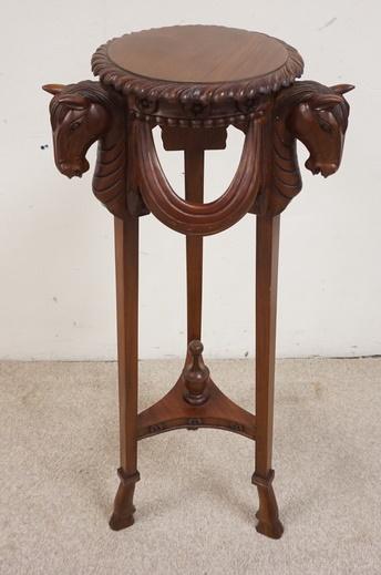 MAHOGANY PEDESTAL WITH CARVED HORSE HEADS: MAHOGANY PEDESTAL WITH CARVED HORSE HEADS, WITH DRAPE GALLERY AND HOOF CARVED FEET.