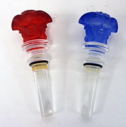 ROSENTHAL VERSACE MEDUSA WINE STOPPERS: ROSENTHAL VERSACE MEDUSA 2 PC. WINE STOPPER LOT. 1 SMALL CHIP AT THE BOTTOM OF THE BLUE STOPPER.