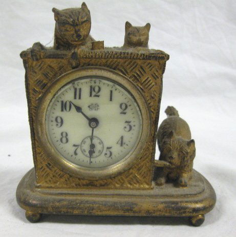 METAL CLOCK, CATS IN A BASKET; 4 1/4 IN H, 4 1/2: METAL CLOCK, CATS IN A BASKET; 4 1/4 IN H, 4 1/2 IN W; ALL CLOCKS SOLD AS IS/AS FOUND. WORKING CONDITION IS UNKNOWN, POSSIBLY MISSING PENDULUM, WEIGHTS, PIECES, PARTS AND/OR KEYS