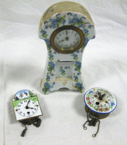 3 CLOCKS, ONE CHINA CASE & 2 MINI ENAMEL WALL CLO: 3 CLOCKS, ONE CHINA CASE & 2 MINI ENAMEL WALL CLOCKS; TALLEST IS 8 IN; ALL CLOCKS SOLD AS IS/AS FOUND. WORKING CONDITION IS UNKNOWN, POSSIBLY MISSING PENDULUM, WEIGHTS, PIECES, PARTS AND/OR KEYS