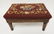 SMALL CARVED STOOL WITH NEEDLEPOINT TOP.