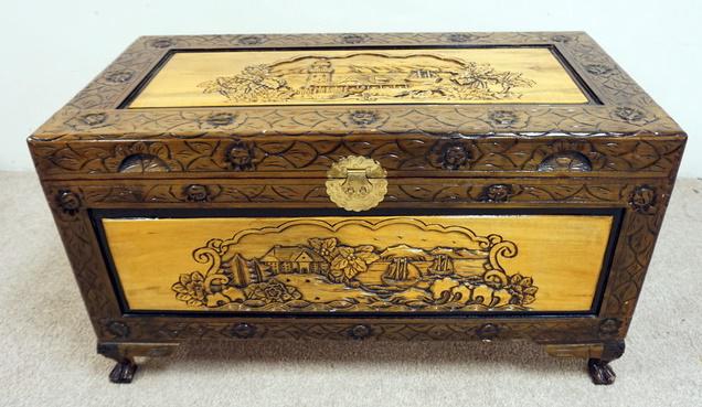 KOREAN CARVED LIFT TOP CHEST: KOREAN CARVED LIFT TOP CHEST. HAS SCENIC CARVING WITH BUILDINGS, SHIPS, ETC. 39 3/4 IN X 20 1/4 IN AND 22 1/2 IN HIGH.