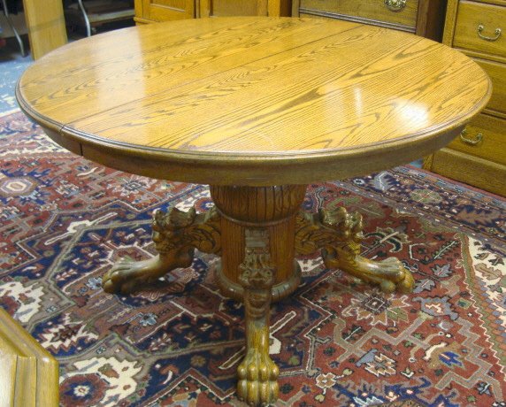 CLAW FOOT ROUND OAK TABLE W/LION HEADS; 48 IN, 30