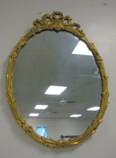 OVAL MIRROR IN GILT FLORAL FRAME W/BOW CREST; OVE