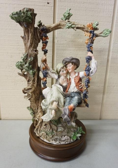 SIGNED COMPOSITION FIGURE: SIGNED COMPOSITION FIGURE OF A MAN & WOMAN ON A TREE SWING