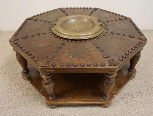 OCTAGONAL SPANISH BRASERS CARVED TABLE: OCTAGONAL SPANISH BRASERS CARVED TABLE, 41 IN ACROSS, 16 1/2 IN HIGH, HAS BRASS INSERT
