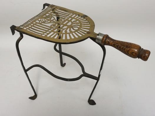 ANTIQUE WROUGHT IRON & BRASS FIREPLACE TRIVET: ANTIQUE WROUGHT IRON & BRASS FIREPLACE TRIVET W/TURNED WOOD HANDLE, 12 IN HIGH