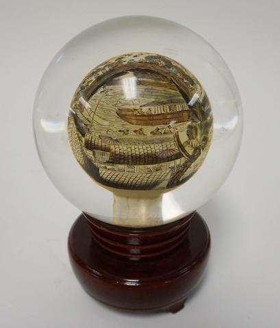 IN PAINTED GLASS GLOBE ON FITTED ROTATING STAND: IN PAINTED GLASS GLOBE ON FITTED ROTATING STAND, 6 1/2 IN HIGH, GLOBE IS APPROXIMATELY 4 1/4 IN DIAMETER