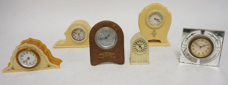 5 DRESSER CLOCKS & A THERMOMETER: FIVE DRESSER CLOCKS & A THERMOMETER. THREE CELLULOID DRESSER CLOCKS A LEATHER ADVERTISING CLOCK FOR HENRY OIL COMPANY MORRISTOWN NJ & CELLULOID THERMOMETER & A NEW HAVEN CLOCK IN A MIRROR FRAME TALLES
