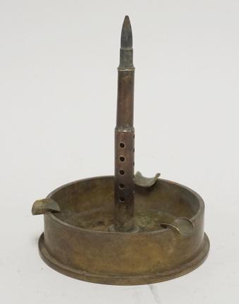 TRENCH ART ASHTRAY: TRENCH ART ASHTRAY BASE IS A 105 MM SHELL DATED 1944 6 5/8 IN H 4 5/8 IN DIAMETER