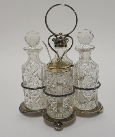 4 BOTTLE CASTOR SET IN SILVER PLATED HOLDER: 4 BOTTLE CASTOR SET IN SILVER PLATED HOLDER, ALL ORIGINAL, 8 IN HIGH