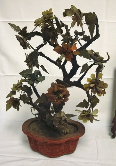 LARGE CARVED STONE FLOWERING TREE IN A CINNABAR P: LARGE CARVED STONE FLOWERING TREE IN A CINNABAR POT, AS FOUND; 22 IN H, APPROX 15 IN W