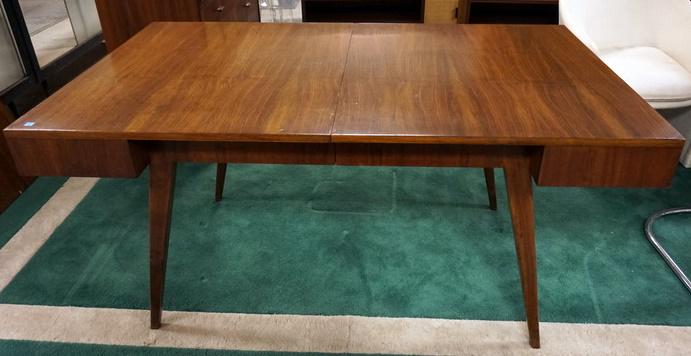 GROSFELD HOUSE MID CNETURY MODERN DINING TABLE: GROSFELD HOUSE MID CNETURY MODERN DINING TABLE, HAS 2 DOVETAILED FITTED SILVER DRAWERS & TWO 18 IN LEAVES, ONE LEAF HAS VENEER CHIP ON A CORNER, TABLE IS 61 5/8 IN X 27 1/4 IN CLOSED, 30 IN HIGH, NOTE