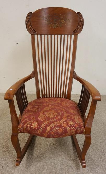CARVED DECORATED ARM ROCKER: CARVED DECORATED ARM ROCKER, HAS SQUARE SPINDLE BACK & SIDES, FLORAL DECORATION ON THE BACK