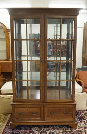 JASPER LIGHTED DISPLAY CABINET: JASPER LIGHTED DISPLAY CABINET HAS MIRROR BACK & GLASS SHELVES & TWO BLIND DOORS AT THE BASE. 46 1/2 IN W 78 IN H
