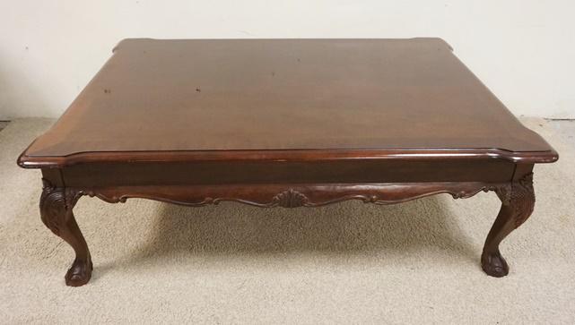 CARVED STANLEY COFFEE TABLE: CARVED STANLEY COFFEE TABLE HAS BALLL & CLAW FEET & TWO PULL OUT SURFACES, APPROXIMATELY 36 IN X 50 IN X 16 1/2 IN HIGH