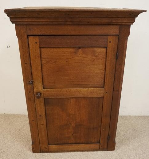 ANTIQUE PRIMITIVE WALNUT HANGING CABINET: ANTIQUE PRIMITIVE WALNUT 1 DOOR HANGING CABINET, LOSSES AT TOP MOLDING, DOVE TAILED TOP, STEP CHAMFORD SIDES AND PANELED DOOR, 28 1/2 IN WIDE X 13 1/4 IN DEEP X 40 IN HIGH