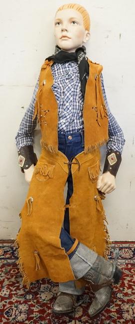 BOY MANNEQUIN DRESSED IN FULL WESTERN WEAR: BOY MANNEQUIN DRESSED IN VINTAGE WRANGLE JEANS, CHAPS AND VEST MARKED USA, VINTAGE JC PENNY WESTERN SHIRT, BANDANNA, DECORATED ARM CUFFS, WESTERN BOOTS AND SPURS. MANNEQUIN IS APPROXIMATLEY 50 IN HIGH