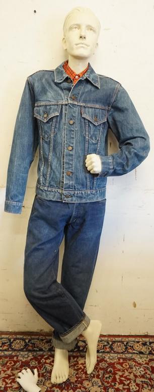 MALE MANNEQUIN CLOTHED WITH SELVEDGE BIG E JEANS: MALE MANNEQUIN CLOTHED WITH SELVEDGE BIG E JEANS, VINTAGE LEVI BIG E JEAN JACKET AND VINTAGE LEVI WILDFIRE SPORTSWEAR SHIRT. MANNEQUIN MISSING AN ARM AND HAS DETACHED HAND AND IS APPROXIMATELY 67 IN T