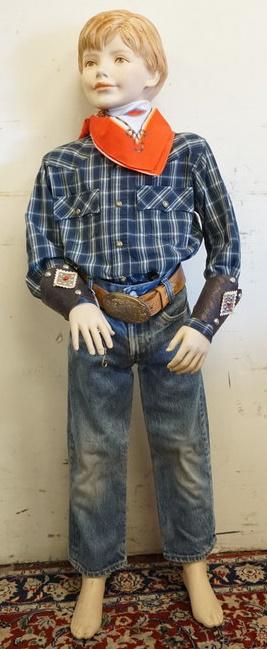 YOUNG BOY MANNEQUIN CLOTHED WITH VINTAGE BIG E LEVI: YOUNG BOY MANNEQUIN CLOTHED WITH VINTAGE BIG E LEVI JEANS, BELT WITH WESTERN THEMED BUCKLE, DECORATED ARM CUFFS, WESTERN BANDANNA AND FADED GLORY WESTERN SHIRT. MANNEQUIN IS APPROXIMATELY 50 IN TALL. 