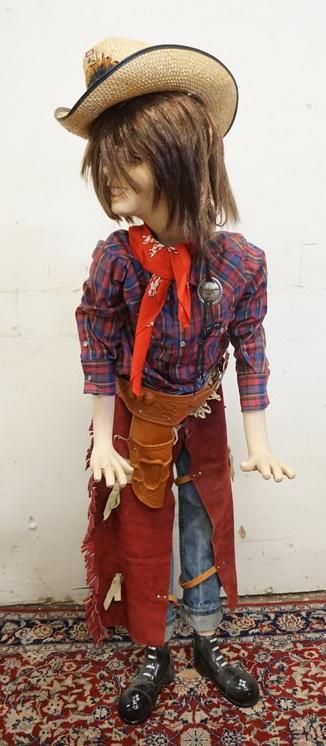 BOY MANNEQUIN CLOTHED IN LEVIS JEANS & WESTERN ATTIRE: BOY MANNEQUIN CLOTHED IN LEVIS JEANS, CHAPS & HOLSTER, PIERRE CARDIN SHIRT, BANDANNA, WIG & A FEATHERED HAT W/ A VINTAGE COCA COLA RODEO PIN. MANNEQUIN MAY SUFFER SOME LOSSES TO BODY/FACE