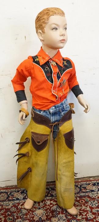 YOUNG BOY MANNEQUIN CLOTHED IN VINTAGE LEVIS & WESTERN: YOUNG BOY MANNEQUIN CLOTHED IN VINTAGE LEVIS JEANS, CHAPS, BOLLO TIE W/ SADDLE CLIP, VINTAGE SEARS WESTERN SHIRT & A NEW JERSEY SHERIFF PIN. APP. 48 IN TALL. MANNEQUIN MAY SUFFER LOSSES TO FACE/BODY