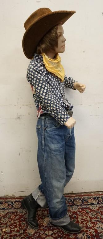 BOY MANNEQUIN CLOTHED IN VINTAGE SELVEDGE LEVIS JEANS: BOY MANNEQUIN CLOTHED IN VINTAGE LEVIS SELVEDGE JEANS W/ BIG E, COWBOY BOOTS, PATRIOTIC WRANGLER SHIRT, BANDANNA, BELT W/ LEVIS BELT BUCKEL, COWBOY HAT & WIG. APP. 60 IN TALL. MANNEQUIN MAY SUFFER LOS