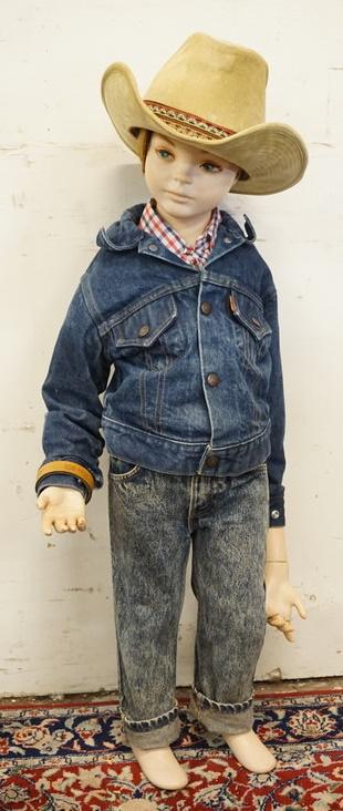 YOUNG BOY MANNEQUIN CLOTHED IN VINTAGE ORANGE TAB LEVIS: YOUNG BOY MANNEQUIN CLOTHED IN VINTAGE ORANGE TAB LEVIS JEANS, A BELT W/ A GUN BELT BUCKLE, A LEVIS DEMIN JACKET, WESTERN SHIRT, & A BOOT HILL COWBOY HAT. APP. 39 IN TALL. MANNEQUIN MAY SUFFER LOSSES