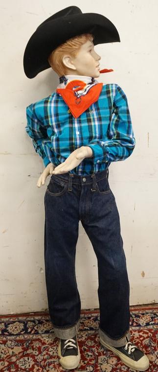 BOY MANNEQUIN CLOTHED IN VINTAGE LEVIS SELVEDGE JEANS: BOY MANNEQUIN CLOTHED IN VINTAGE LEVIS SELVEDGE JEANS W/ BIG E, PRO KEDS SNEAKERS, WRANGLER SHIRT, BANDANNA, RELIGIOUS NECKLACE, WESTERN EXPRESS INC. COWBOY HAT. APP. 56 IN TALL. MANNEQUIN MAY SUFFER