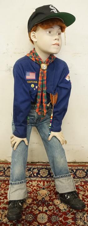 BOY MANNEQUIN CLOTHED IN LEVIS JEANS & BOY SCOUTS: BOY MANNEQUIN CLOTHED IN LEVIS JEANS, SNEAKERS, BASEBALL CAP, SHIRT W/ BOY SCOUTS RELATED PINS & PATCHES, SCARF W/ A BOY SCOUTS CLIP, & A BELT W/ BOY SCOUTS BELT BUCKLE.APP. 44 IN TALL MANNEQUIN MAY S