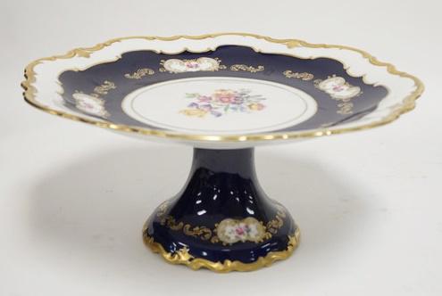 EAST GERMAN DECORATED PORCELAIN CAKE PLATE: EAST GERMAN DECORATED PORCELAIN CAKE PLATE TRIMMED IN COBALT BLUE & GOLD. 13 IN DIAMETER 6 IN H