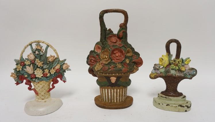 GROUP OF 3 CAST IRON FLOWER BASKET DOOR STOPS: GROUP OF 3 CAST IRON FLOWER BASKET DOOR STOPS, LARGEST IS 12 IN HIGH