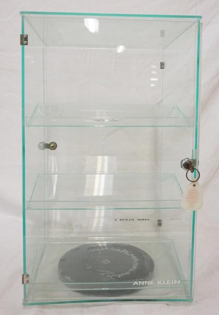 3 TIER PLASTIC DISPLAY SHOW CASE W/ LOCKING DOORS: THREE TIER PLASTIC DISPLAY SHOW CASE W/ LOCKING DOORS & KEYS ON BOTH SIDES, IT IS ALSO ON A TURNTABLE. 22 IN X 13 IN. 12 IN DEEP