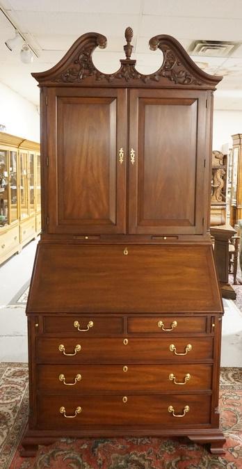 HENKEL HARRIS WALNUT SECRETARY DESK: HENKEL HARRIS WALNUT SECRETARY DESK, 2 PART SOLID WALNUT W/BLIND DOORS & CARVED ARCH PEDIMENT TOP, PULL OUT CANDLE HOLDERS & REEDED QUARTER COLUMNS, 94 IN HIGH X 40 IN WIDE X 22 IN DEEP