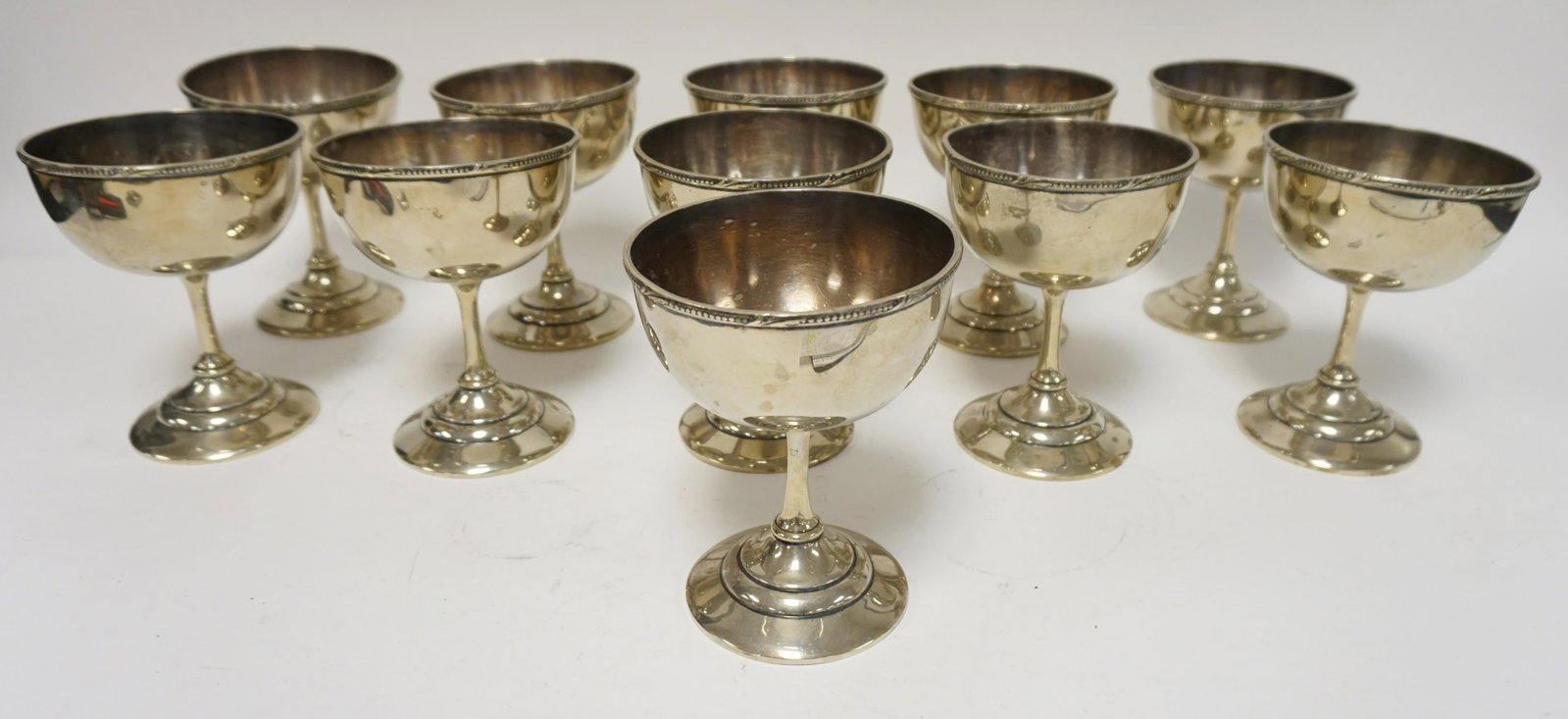 GROUP OF 11 SILVER PLATE GOBLETS MARKED THE RALEIGH: GROUP OF 11 SILVER PLATE GOBLETS MARKED THE RALEIGH UNDERNEATH, 6 3/4 IN HIGH, 5 1/4 IN ROUND