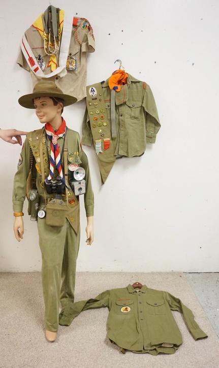 MANNEQUIN CLOTHED IN BOY SCOUTS UNIFORM & BOY SCOUTS: MANNEQUIN CLOTHED IN BOY SCOUTS UNIFORM, SASH W/ PATCHES, BOY SCOUTS CAMERA, CANTEEN, FLASH LIGHT, BOY SCOUTS FIRST AIDE KIT, SCARF W/ A CLIP THAT READS *DISTRICT CAMPOREE 1949* A BOY SCOUTS HAT. IT I