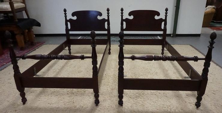 PAIR OF CARVED MAHOGANY TWIN BEDS: PAIR OF CARVED MAHOGANY TWIN BEDS, TURNED FEET, LEAF CARVED FINIALS, HEADBOARD IS 42 1/2 IN HIGH, FOOTBOARD IS 38 IN HIGH, BOTH ARE 41 IN WIDE