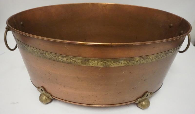 LARGE COPPER OVAL POT WITH BRASS TRIM: LARGE COPPER OVAL POT WITH BRASS TRIM, HAS A DECORATIVE BRASS BAND, FEET AND RING HANDLES, 24 1/2 IN X 17 1/2 IN, 11 IN HIGH