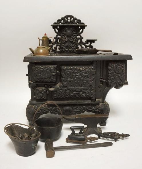 ACME CAST IRON TOY STOVE: ACME CAST IRON TOY STOVE W/ ACCSESSORIES 11 IN W, 12 1/2 IN H