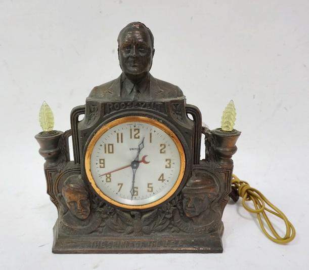 METAL ROOSEVELT CLOCK: METAL ROOSEVELT CLOCK TITLED *IN THE SPIRIT OF THE USA* 11 IN X 9 1/2 IN X 4 IN