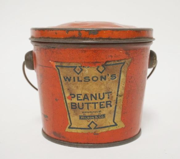 WILSONS PEANUT BUTTER TIN: WILSONS PEANUT BUTTER TIN, TOP HAS SOME DENTS, 4 IN HIGH X 4 IN TOP DIAMETER