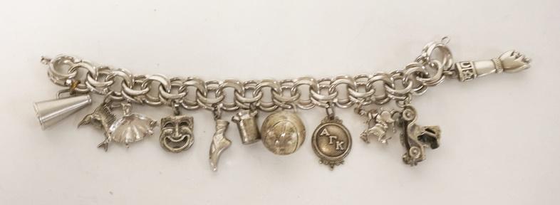 STERLING SILVER CHARM BRACELET: STERLING SILVER CHARM BRACELET, FIST CHARM MARKED 800 WITH AN ANCHOR, MILK CAN AND MEDALLION MARKED STERLING, 8 OTHER CHARMS NO MARKING FOUND. 7 IN LONG, 2.55 TOZ