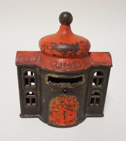 *PRESTO BANK* BUILDING STILL BANK: *PRESTO BANK* BUILDING STILL BANK, ALSO MARKED *PAT APD*, RED DECORATION, HAS SPRING BUTTON, CAST IRON, 3 3/4 IN WIDE X 4 1/2 IN HIGH