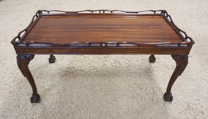 MAHOGANY BALL & CLAW FOOT COFFEE TABLE: MAHOGANY BALL & CLAW FOOT COFFEE TABLE HAS A FRETWORK GALLERY & CARVED KNEES. 35 1/2 IN X 18 1/2 IN, 17 1/2 IN H